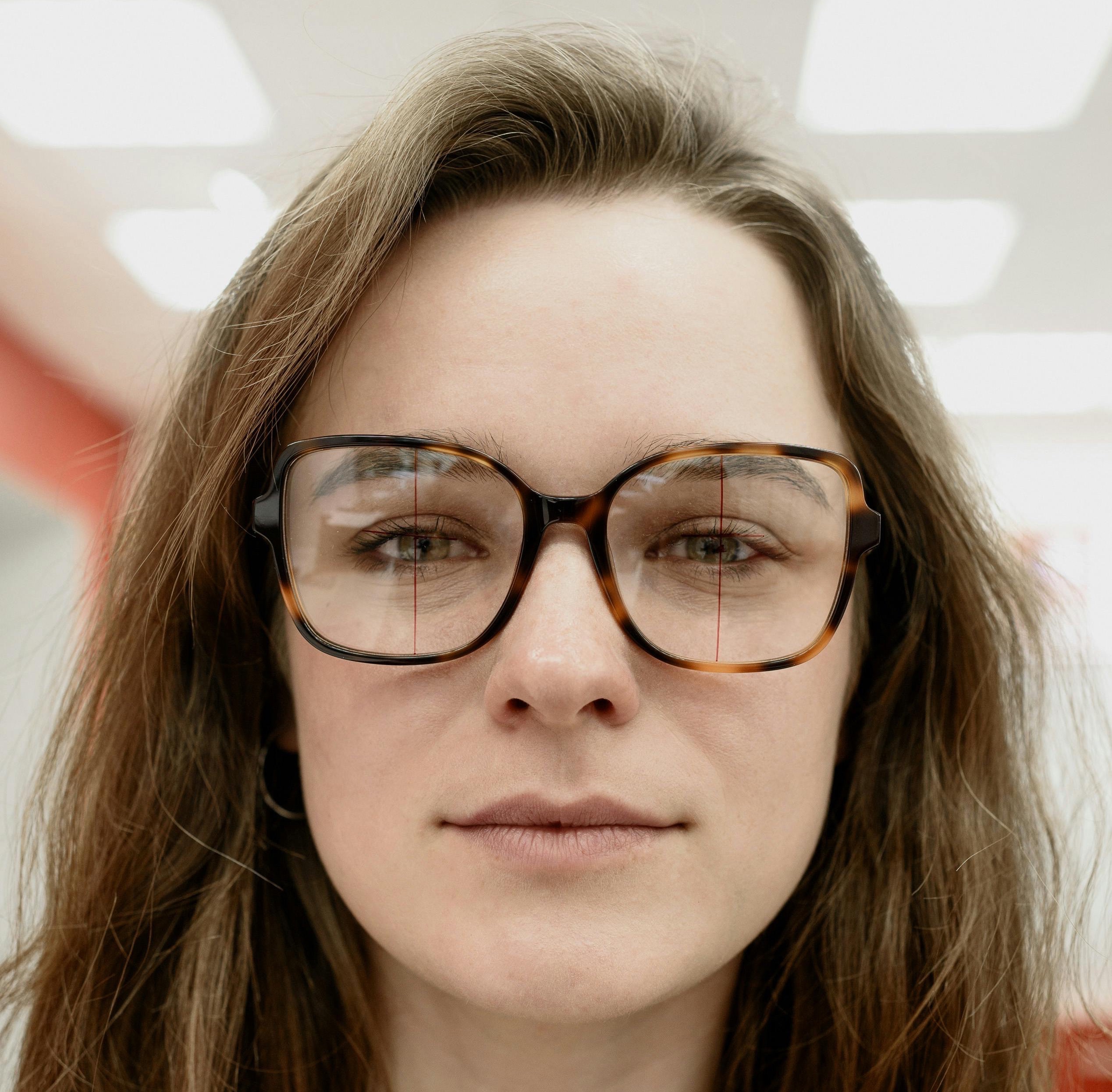 Woman wearing glasses with PD markings